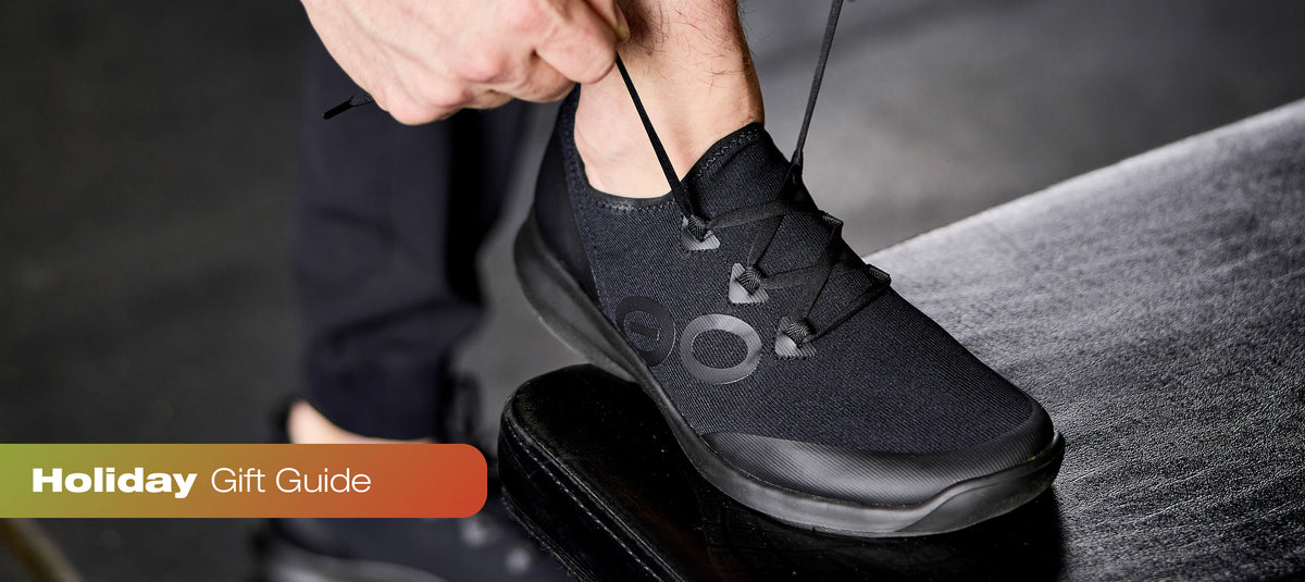 Close up of model adjusting laces on oomg sport ls black