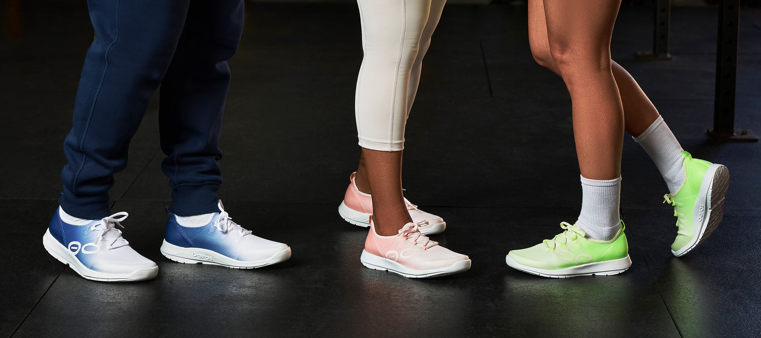 Navy, Blush, and Mello Mutare Recovery Shoes in a gym setting