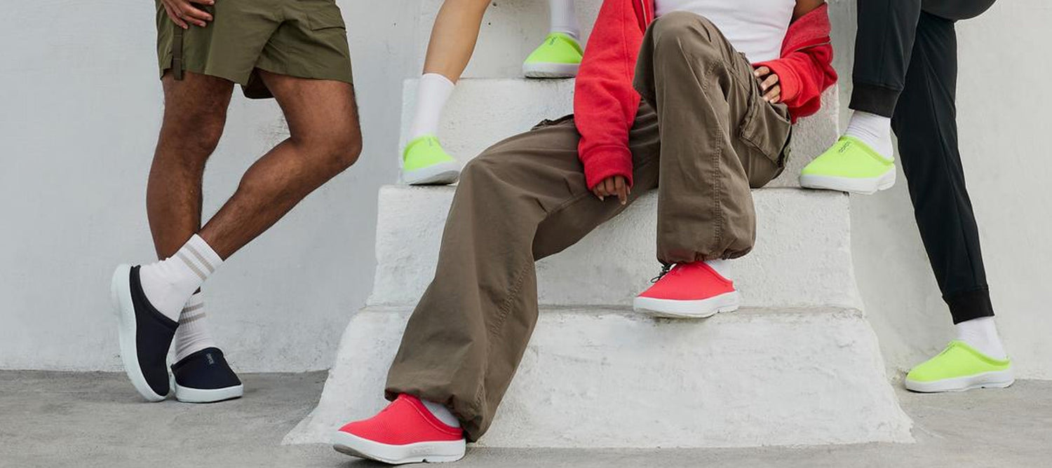 models outside sitting on step wearing oocoozie sport navy, oocoozie sport neon berry, and oocoozie sport electro