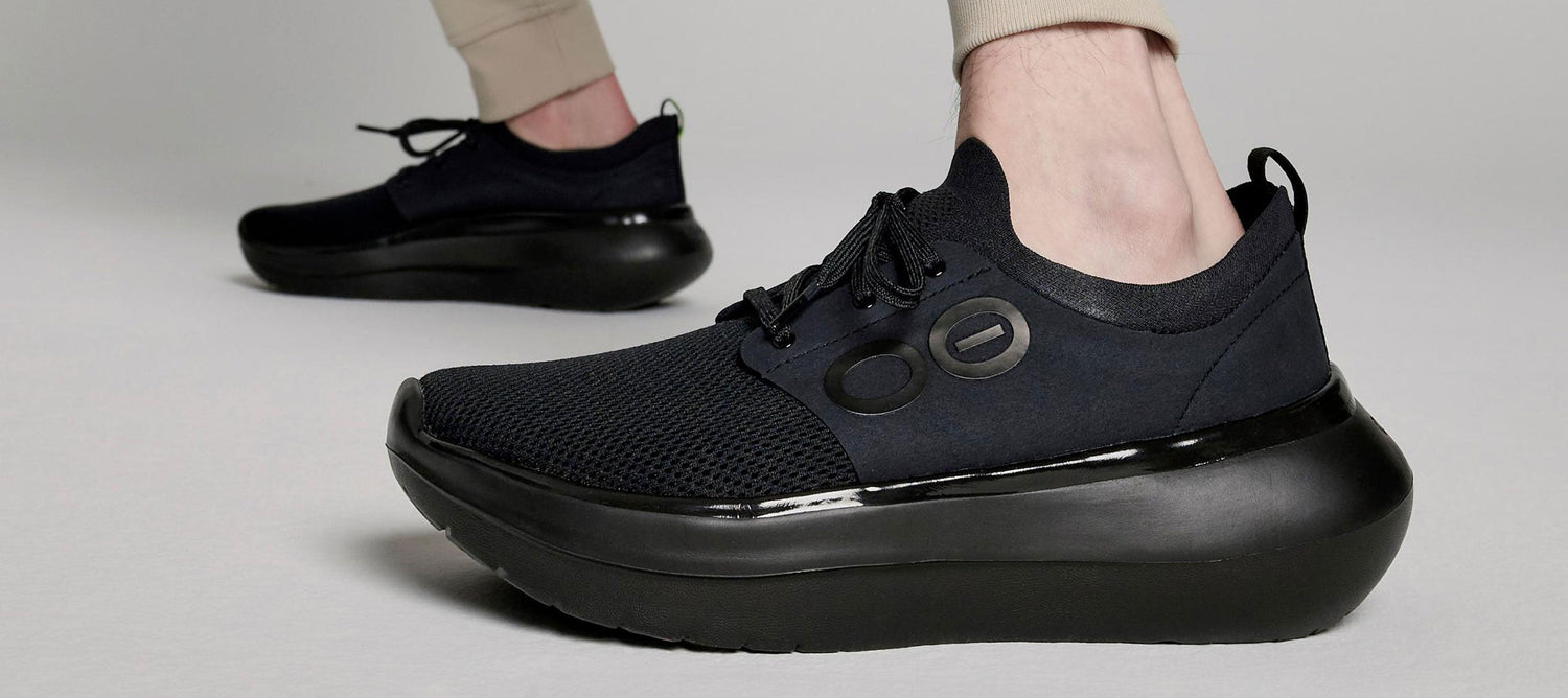 model in studio wearing oomy stride black