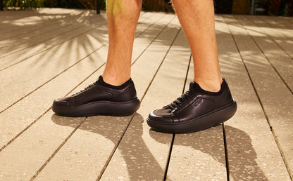 Black sneakers on a wooden floor | lifestyle