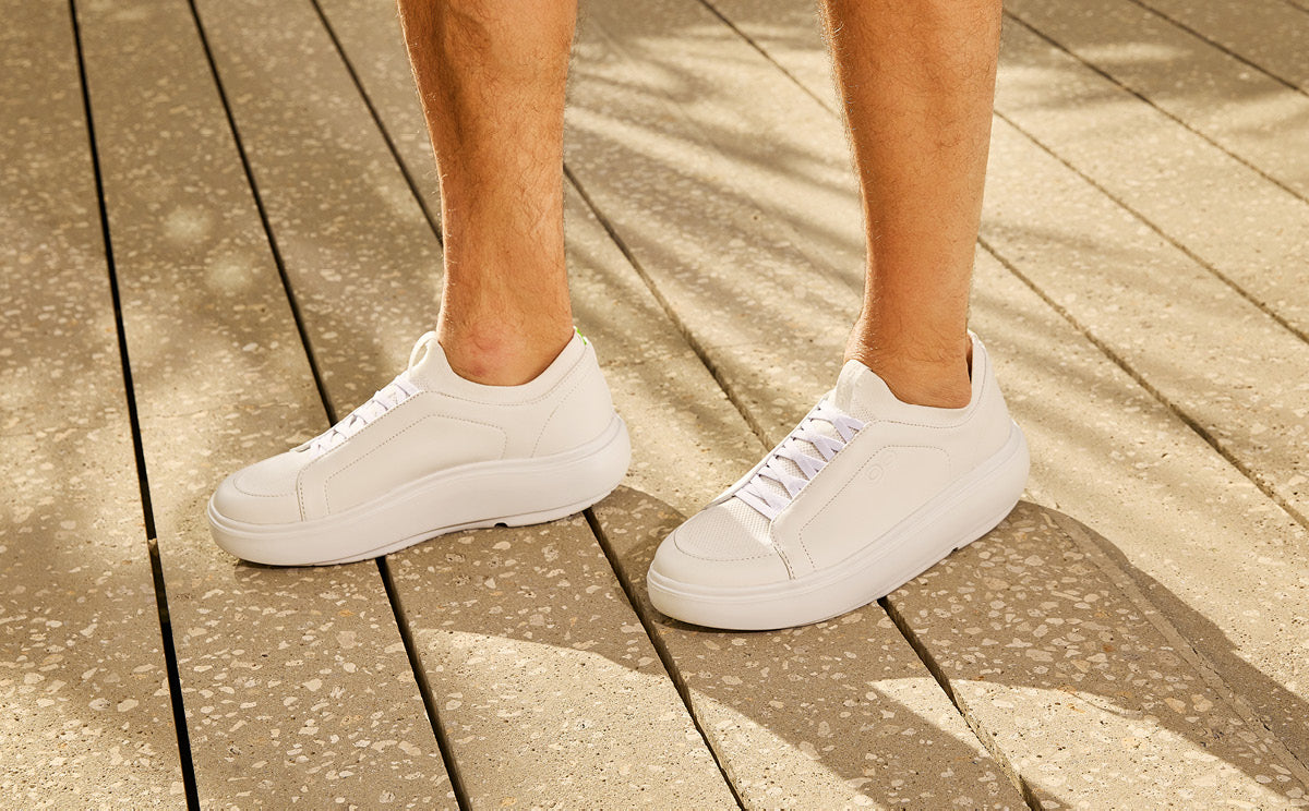 White sneakers on a wooden floor | lifestyle