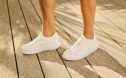 White sneakers on a wooden floor | lifestyle