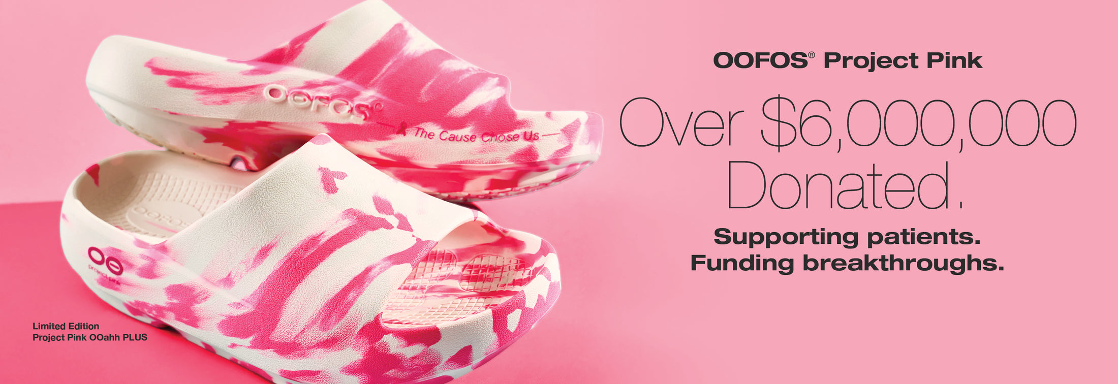 Pink and white OOFOS shoes on a pink background with text about donations.