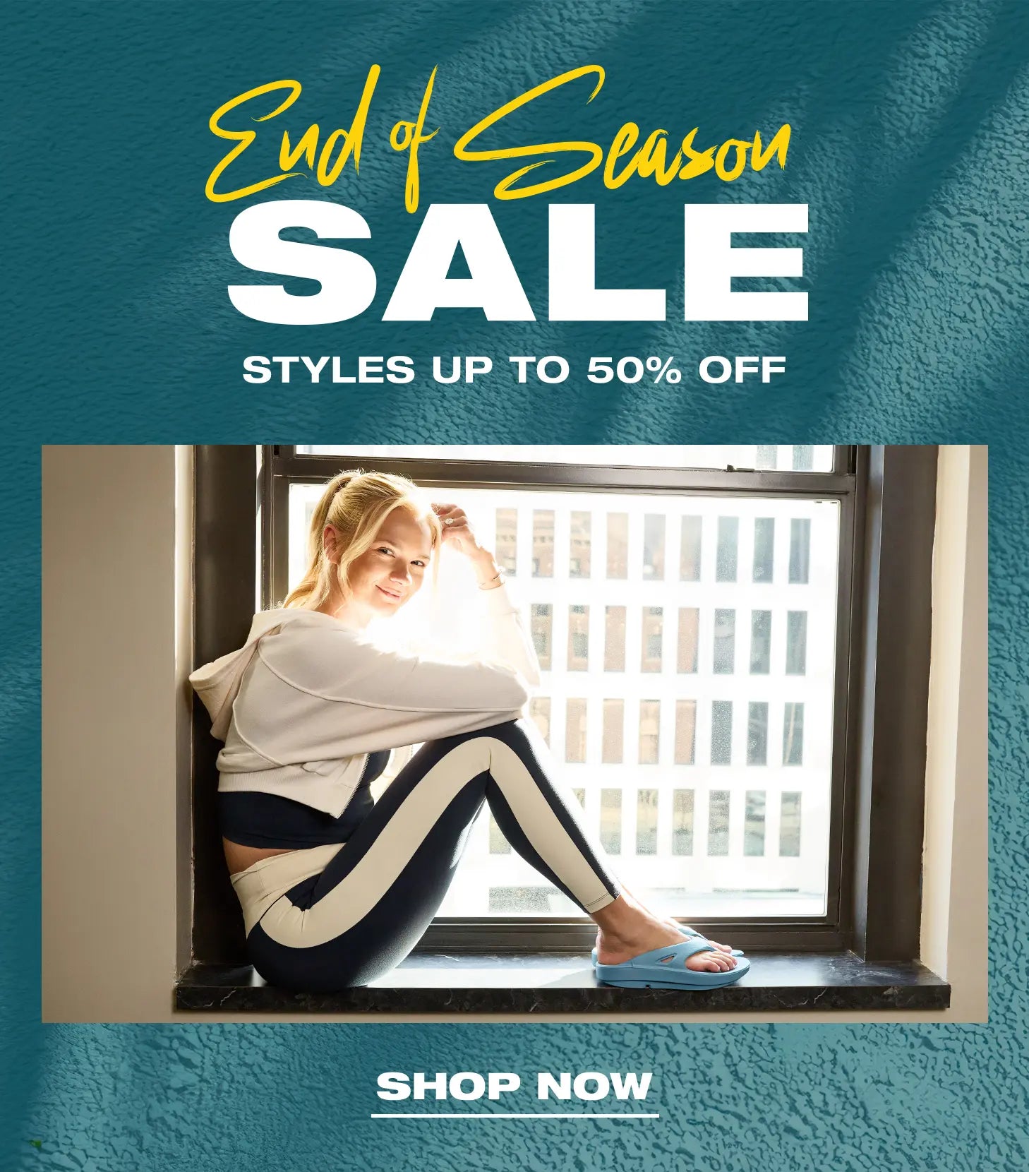 Promotional sale graphic with a woman sitting by a window wearing a white hoodie and black-and-white leggings, set against a textured teal background with large text reading 'End of Season SALE' and 'SHOP NOW'.