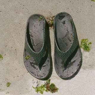 oofos adsum sandals on beach
