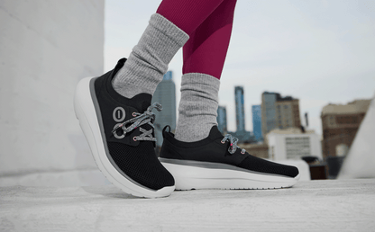 Women's OOmy Stride - White Black model posing outside | lifestyle