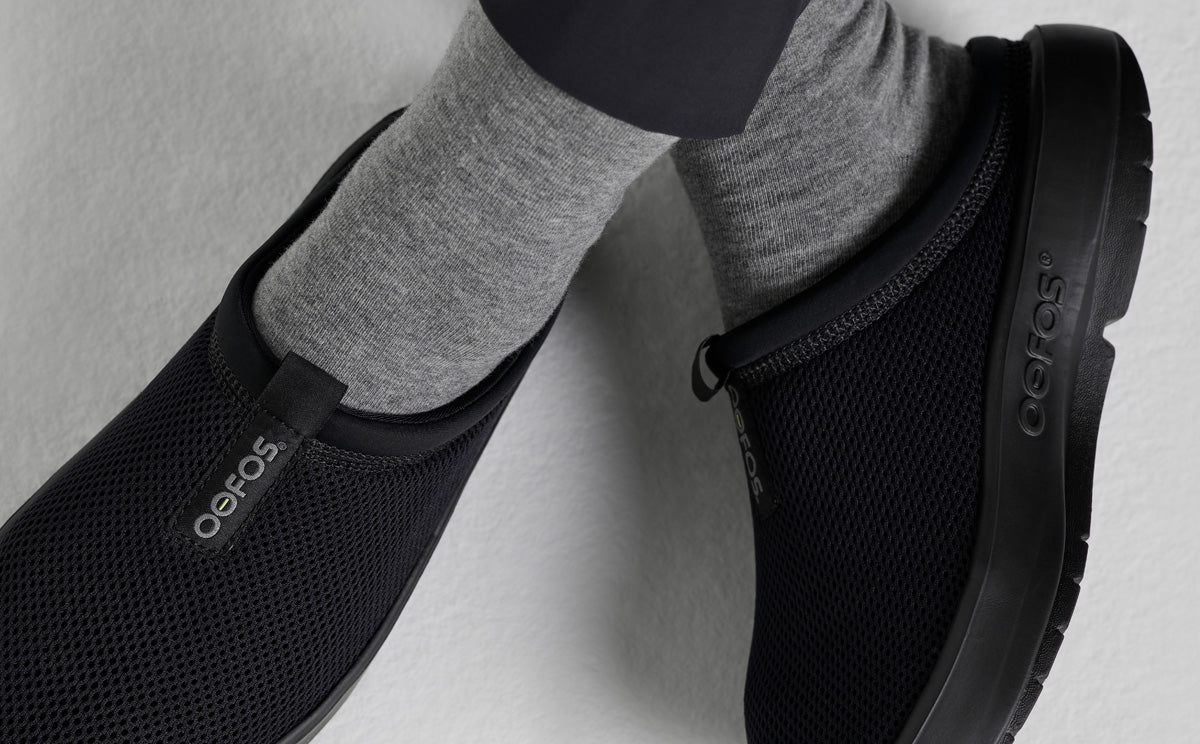 Women's OOcoozie Sport Mule - Black top view close up of shoes on models feet in studio | lifestyle