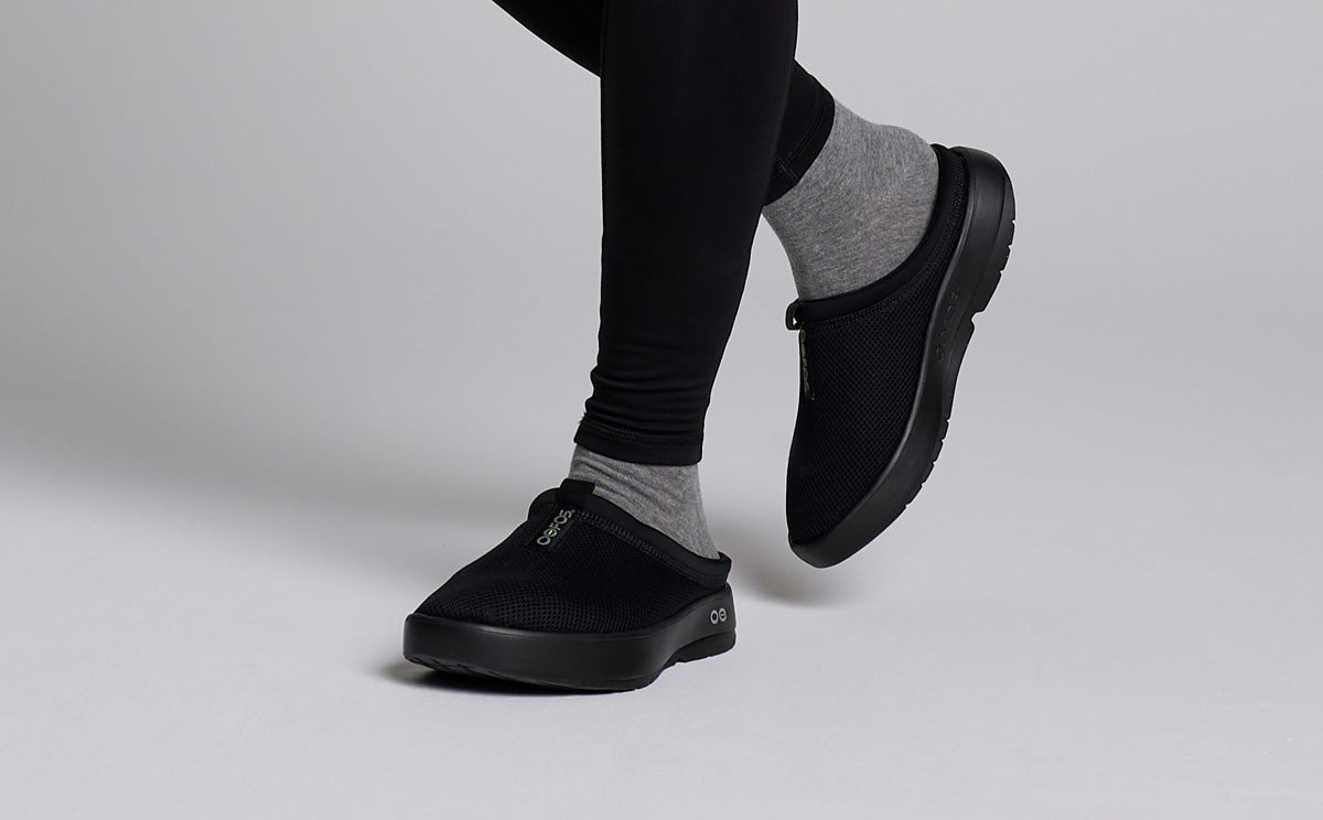 Men's OOcoozie Sport Mule - Black model standing in studio | lifestyle