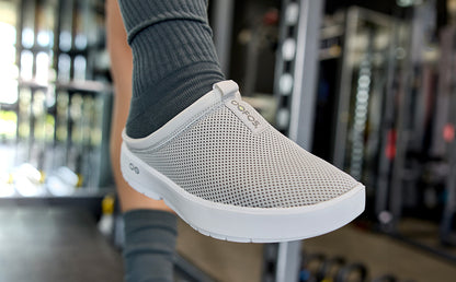 Women's OOcoozie Sport Mule - Gray close up of shoe on model in gym | lifestyle