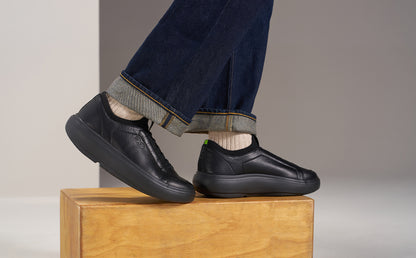 model standing on block in studio wearing black club plus | lifestyle