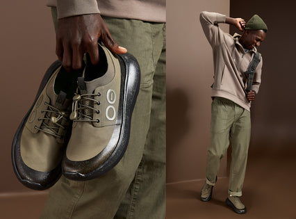 A split image showing a person holding a pair of olive green and black low-top sneakers, with the other side showing the person wearing the same sneakers in a studio setting.