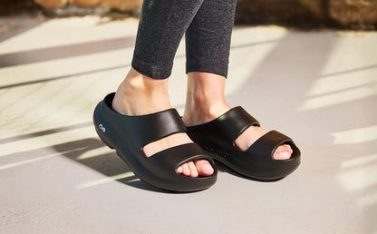Women's OOyea Slide Sandal - Black model walking outside | lifestyle