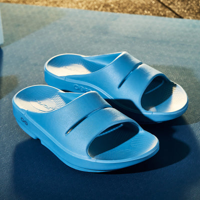 Blue sandals on gym mat surface