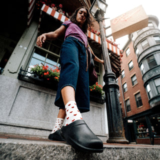 model standing on sidewalk in city wearing oocloog black