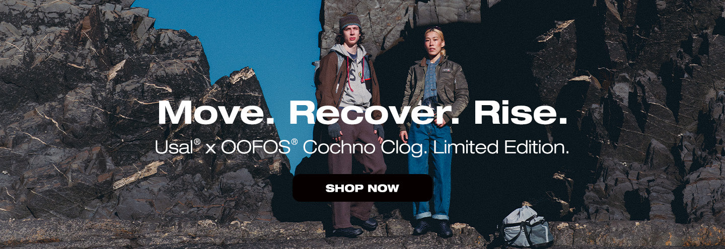 Two people standing on a rocky cliff with promotional text for Usual x OOFS Cochoo Clog Limited Edition.