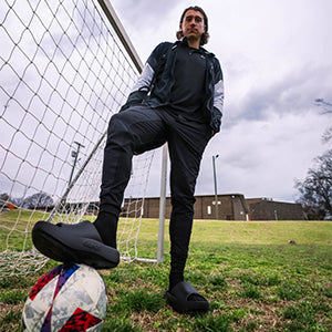 Man with soccer ball wearing OOahh PLUS in black