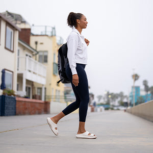 women wearing OOyea slides crossing street