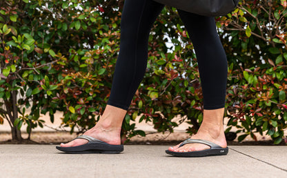 Women's OOlala Sandal - Latte - OOFOS close up of model walking in shoes | lifestyle
