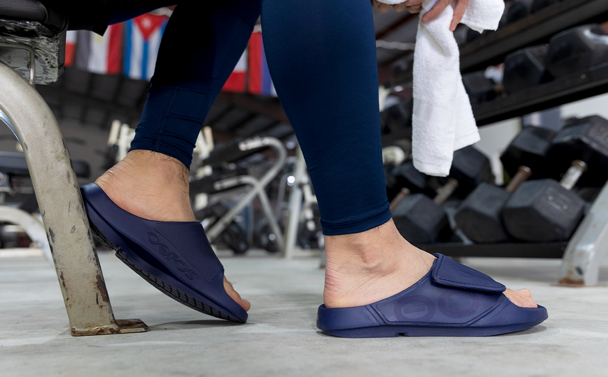 Men's OOahh Sport Flex Sandal - Navy side view of model weaaring shoes | lifestyle