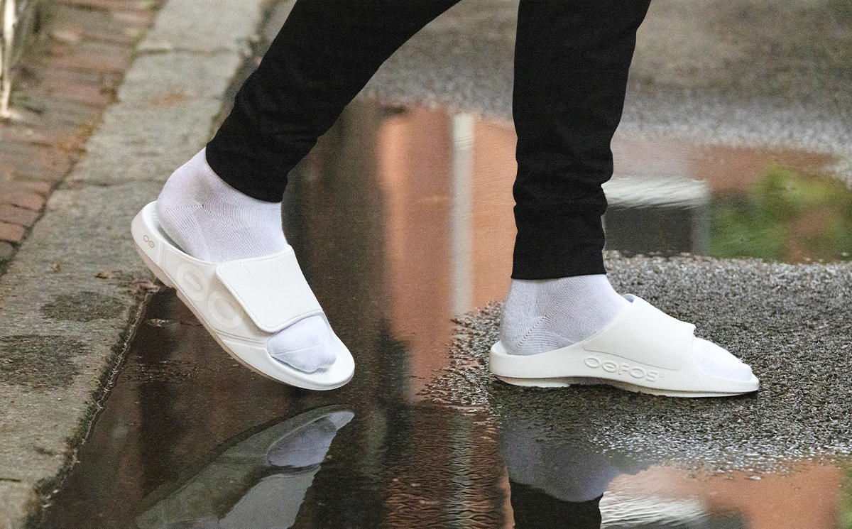 Men's OOahh Sport Flex Sandal - White model walking over puddle in shoes | lifestyle